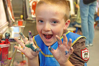 Malcolm paints at the Denver childrens museum.