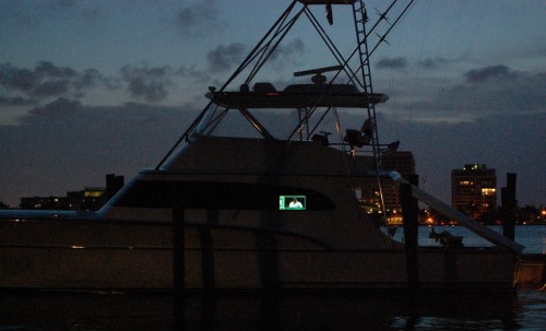 Palm Beach yacht with TV at dusk