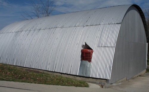 Tractor on Missouri farm pokes through shed