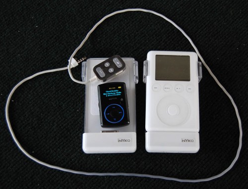 iPod, spare batteries, remote control and SanDisk Sansa Clip